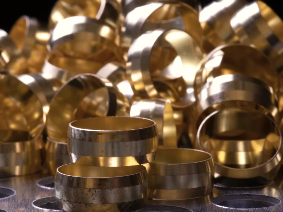 Brass compression ferrules and olives grouped on a metal tray