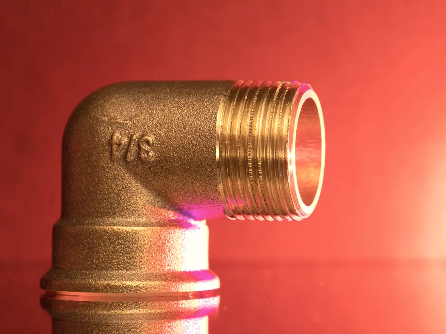 Brass elbow fitting with a male threaded outlet