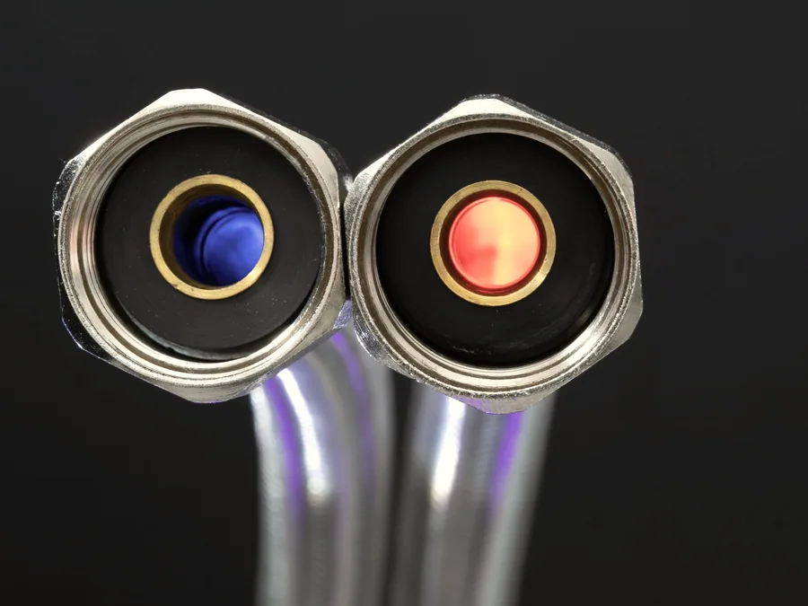 Two hose assemblies seen end-on, showing female swivel nuts and coloured seal inserts