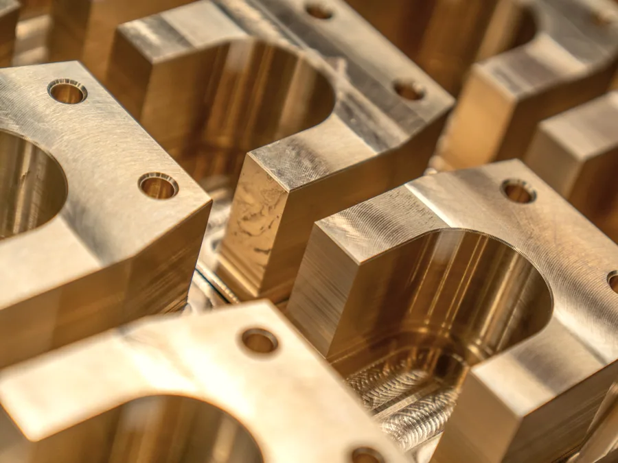 Machined brass manifold blocks with bored ports and mounting holes