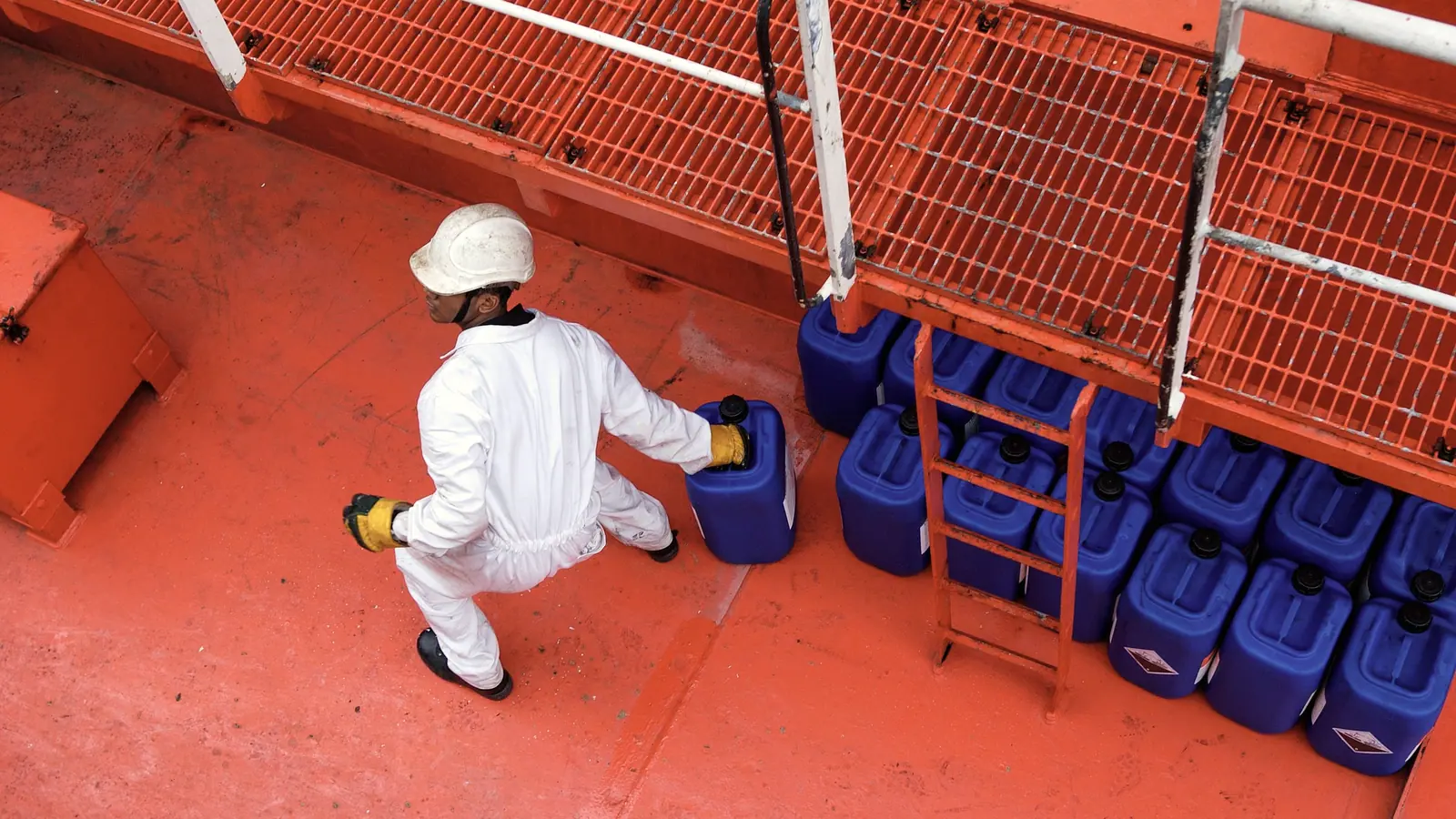 Crew handling supplies on a vessel deck