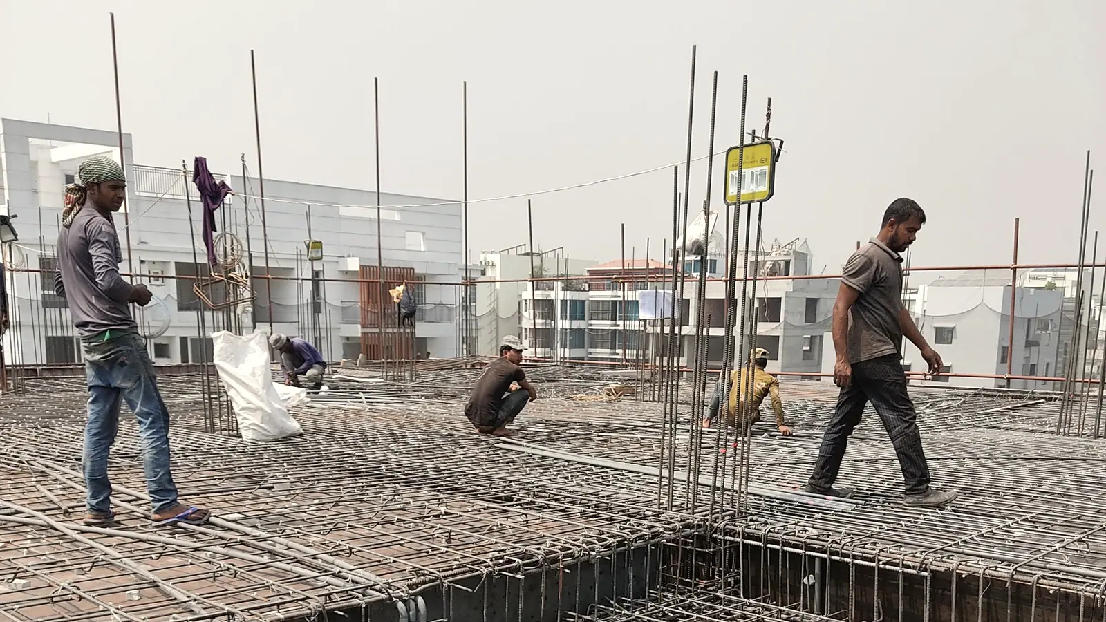 Site crew working across a reinforcement mat on a slab