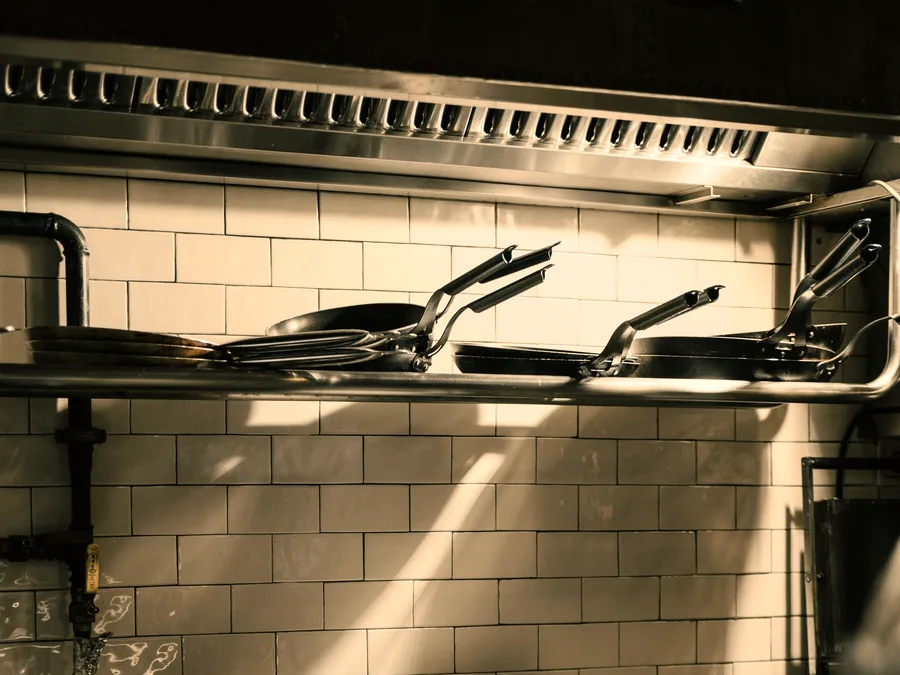 Commercial galley range with stainless surfaces and cooking pots