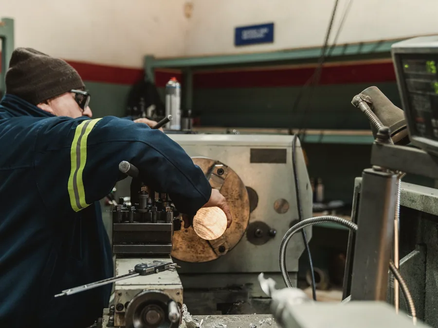 Technician working at a machine in an engineering workshop