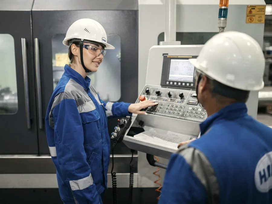 Engineers assembling and setting up equipment at a control panel