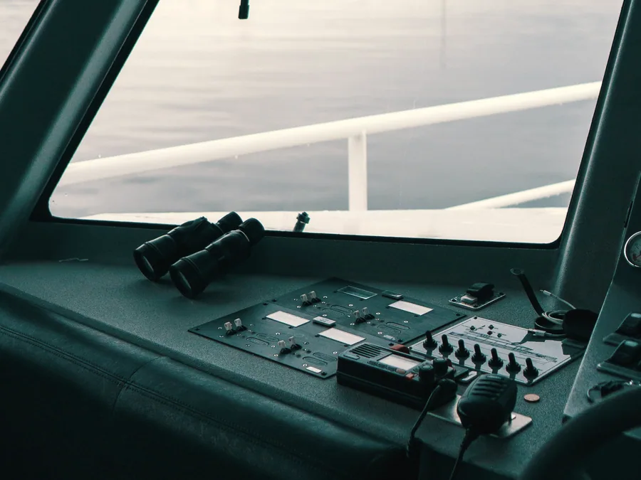 Vessel wheelhouse console showing steering controls and instruments