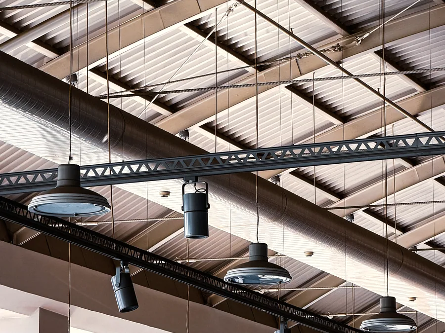 Industrial pendant light fittings under a warehouse roof