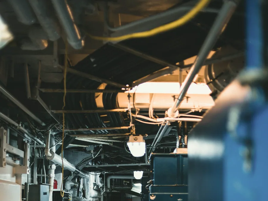 Lit engine room passageway with distribution equipment