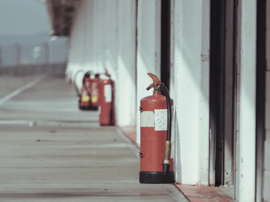 Fire extinguishers stationed along an industrial alleyway