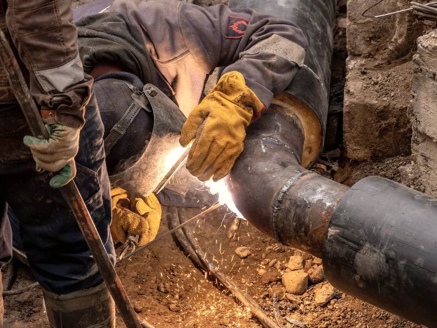 Pipe being cut and prepared for installation on site