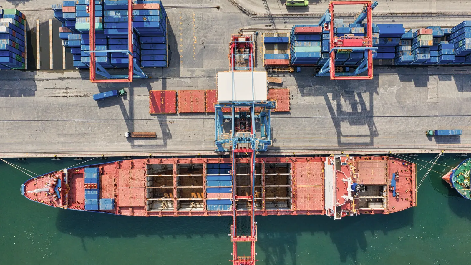 Aerial view of a cargo vessel loading alongside the quay at a container terminal